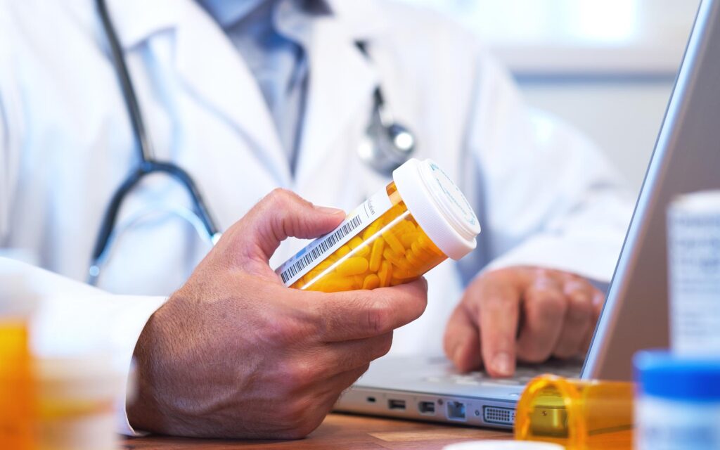 Doctor preparing online internet prescription